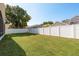The backyard features green grass and a white vinyl fence at 1285 Salt Lake Dr, Tarpon Springs, FL 34689