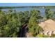 Scenic backyard view featuring a dock, lush greenery, and partial view of the pool at 1285 Salt Lake Dr, Tarpon Springs, FL 34689