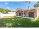 Exterior view of a house featuring a screened-in lanai and a well-kept lawn at 1285 Salt Lake Dr, Tarpon Springs, FL 34689