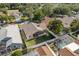 Aerial view of a home's fenced backyard, featuring a screened-in porch and pool area at 1285 Salt Lake Dr, Tarpon Springs, FL 34689