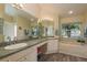 Bathroom with dual sinks, large mirror, tub and garden views at 1285 Salt Lake Dr, Tarpon Springs, FL 34689