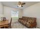 Bedroom featuring a futon, ceiling fan, and desk, creating a versatile and comfortable space at 1285 Salt Lake Dr, Tarpon Springs, FL 34689