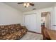 Bedroom with a futon, closet, and ceiling fan overlooking the hallway at 1285 Salt Lake Dr, Tarpon Springs, FL 34689