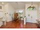 Bright dining area featuring wood floors, chandelier, and adjacent front entry at 1285 Salt Lake Dr, Tarpon Springs, FL 34689