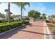 Secured gated community entrance with brick-paved road and lush greenery at 1285 Salt Lake Dr, Tarpon Springs, FL 34689