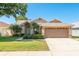 Charming single Gathering home featuring manicured lawn, mature trees, and two car garage at 1285 Salt Lake Dr, Tarpon Springs, FL 34689