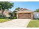 Well-maintained home featuring a lush green lawn and a large two-car garage, offering ample space for parking at 1285 Salt Lake Dr, Tarpon Springs, FL 34689