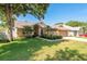 Charming single Gathering home featuring manicured lawn, mature trees, and a two car garage at 1285 Salt Lake Dr, Tarpon Springs, FL 34689