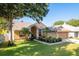 Beautiful exterior of a home showcasing a manicured lawn and a two-car garage at 1285 Salt Lake Dr, Tarpon Springs, FL 34689