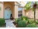 Inviting front entrance with a light blue door, neat landscaping, and a welcoming bench for guests at 1285 Salt Lake Dr, Tarpon Springs, FL 34689