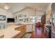 Well lit kitchen with hardwood floors and modern appliances with views to Gathering room at 1285 Salt Lake Dr, Tarpon Springs, FL 34689