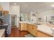 Bright kitchen featuring ample counter space, wood cabinets, and hardwood floors at 1285 Salt Lake Dr, Tarpon Springs, FL 34689