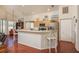 Open kitchen with a large island, modern appliances, and wood floors at 1285 Salt Lake Dr, Tarpon Springs, FL 34689