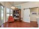 Comfortable sitting area with bookshelf, chair, and sliding barn door, creating a cozy space for relaxation and reading at 1285 Salt Lake Dr, Tarpon Springs, FL 34689