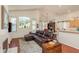 Comfortable living room with vaulted ceiling, wood floors, and plenty of natural light at 1285 Salt Lake Dr, Tarpon Springs, FL 34689