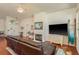 Inviting living room featuring a fireplace, leather sofa, and view of the front entry and staircase at 1285 Salt Lake Dr, Tarpon Springs, FL 34689
