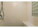 Tiled shower stall with built-in bench and glass block window at 1285 Salt Lake Dr, Tarpon Springs, FL 34689