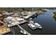 Aerial view of a waterfront area featuring a seafood restaurant, docks, and several boats at 1285 Salt Lake Dr, Tarpon Springs, FL 34689