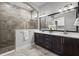 Bathroom featuring a large vanity, and a glass shower with decorative tile at 15329 Renaissance Ave, Odessa, FL 33556