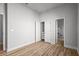 Neutral bedroom features plank floors, closet, and views into the bathroom at 15329 Renaissance Ave, Odessa, FL 33556
