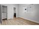 Bright bedroom features wood-look floors, a window, closet, and ensuite bathroom at 15329 Renaissance Ave, Odessa, FL 33556