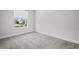 Bright bedroom featuring a window with neighborhood views and neutral carpet at 15329 Renaissance Ave, Odessa, FL 33556