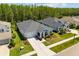 Well-manicured home with a light blue exterior, landscaped garden, and a concrete driveway at 15329 Renaissance Ave, Odessa, FL 33556