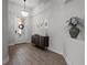 Elegant foyer featuring wood-look tile flooring, decorative lighting, and stylish decor at 15329 Renaissance Ave, Odessa, FL 33556