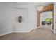 Hallway with wood-look tile flooring leading to an archway and a glimpse of the living space at 15329 Renaissance Ave, Odessa, FL 33556