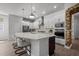 Bright kitchen with white cabinets, stainless steel appliances, and a large island with seating at 15329 Renaissance Ave, Odessa, FL 33556