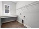 Functional laundry room with tile floors, counter space, and wire shelving at 15329 Renaissance Ave, Odessa, FL 33556