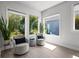 Cozy sitting area with serene outdoor views, complemented by neutral-toned swivel chairs and wood-look flooring at 15329 Renaissance Ave, Odessa, FL 33556