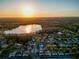 Aerial view of homes and lake at sunset showcasing community and natural beauty at 16819 Stanza Ct, Tampa, FL 33624