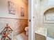 Elegant bathroom featuring detailed tilework, a built-in shower bench, and a decorative wall niche at 16819 Stanza Ct, Tampa, FL 33624