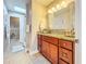 Bathroom featuring a large vanity, shower, and neutral tile flooring at 16819 Stanza Ct, Tampa, FL 33624