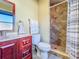Bathroom featuring a traditional vanity, neutral decor, and a fully tiled walk-in shower at 16819 Stanza Ct, Tampa, FL 33624
