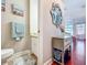 Cozy half bath with beach themed wall art and decorative hand towels at 16819 Stanza Ct, Tampa, FL 33624