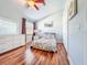 Cozy bedroom with hardwood floors, a ceiling fan, and a double-door closet at 16819 Stanza Ct, Tampa, FL 33624