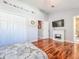 Bright bedroom with hardwood flooring, a closet, and electric fireplace at 16819 Stanza Ct, Tampa, FL 33624