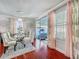 Elegant dining room features a glass table, stylish chairs, chandelier, and sliding glass doors to the lanai at 16819 Stanza Ct, Tampa, FL 33624