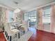 Bright dining room featuring a chandelier, large windows, and access to a patio at 16819 Stanza Ct, Tampa, FL 33624
