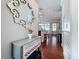 Inviting foyer with beautiful decor and hardwood floors, creating a warm and welcoming ambiance with view to kitchen at 16819 Stanza Ct, Tampa, FL 33624