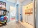 Hallway view that shows a laundry area and a view to the half bathroom at 16819 Stanza Ct, Tampa, FL 33624