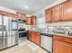 Updated kitchen with stainless steel appliances, granite countertops, and rich wood cabinetry at 16819 Stanza Ct, Tampa, FL 33624