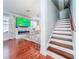 Inviting living room with modern fireplace, large screen TV, and staircase access at 16819 Stanza Ct, Tampa, FL 33624
