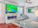 Comfortable living room with a fireplace, large screen TV, and modern decor at 16819 Stanza Ct, Tampa, FL 33624