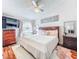 Comfortable bedroom featuring a ceiling fan, chandelier, and large mirror at 16819 Stanza Ct, Tampa, FL 33624