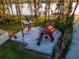 Charming community playground featuring a wooden play structure, swings, and a sandy play area near the lake at 16819 Stanza Ct, Tampa, FL 33624