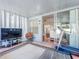 Enclosed sunroom with television, decorative rug, and sliding glass doors at 16819 Stanza Ct, Tampa, FL 33624