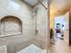 Shower featuring neutral tile and shower niche at 16819 Stanza Ct, Tampa, FL 33624